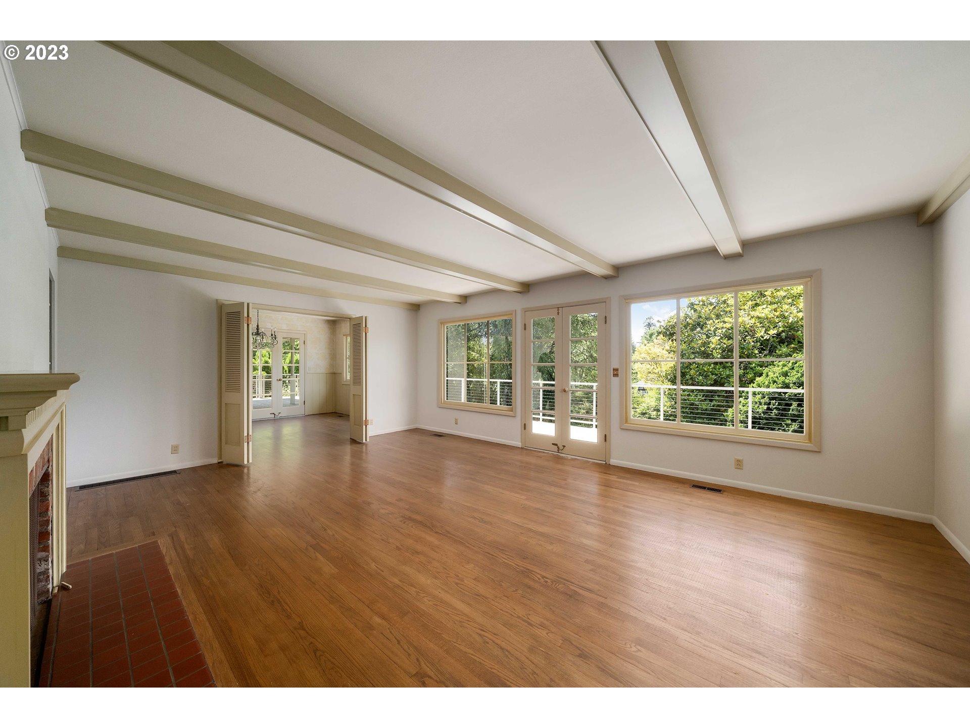 3815 Southwest 50th Avenue Portland, OR 97221 - Photo 8 of 36 a view of an empty room with wooden floor and a window