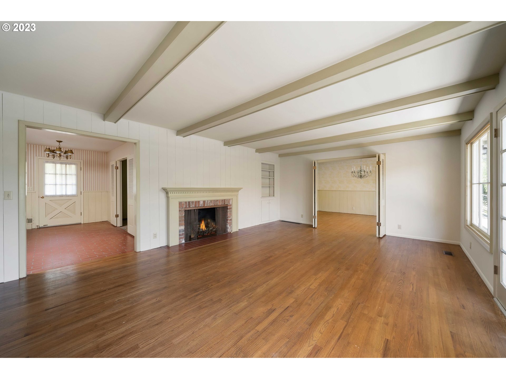 3815 Southwest 50th Avenue Portland, OR 97221 - Photo 9 of 36 a view of empty room with wooden floor and fireplace