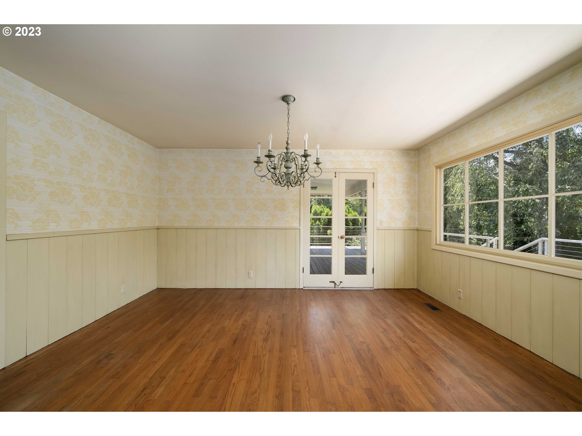 3815 Southwest 50th Avenue Portland, OR 97221 - Photo 10 of 36 a view of wooden floor in an empty room with a window