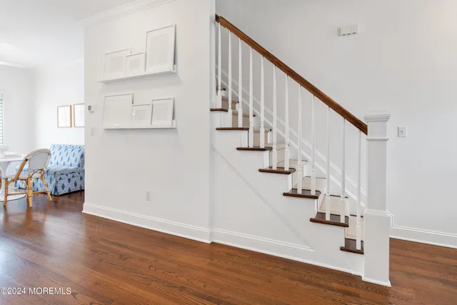 a view of entryway and hall with wooden floor