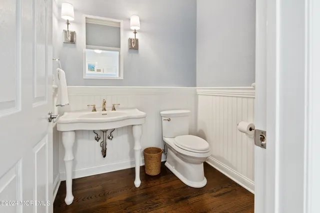 a bathroom with a sink toilet and a mirror