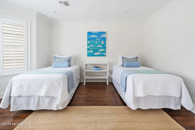 a bedroom with a bed and a wooden floor