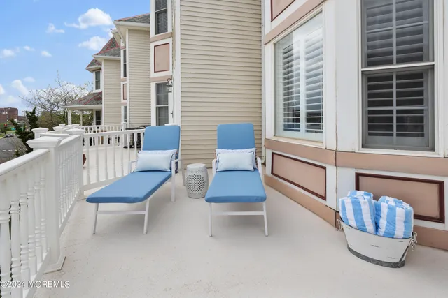 a view of a patio with couches chairs and a potted plant