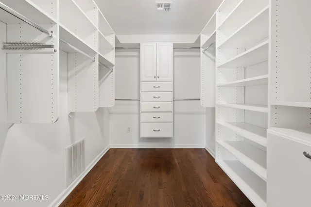 a view of walk in closet with empty racks