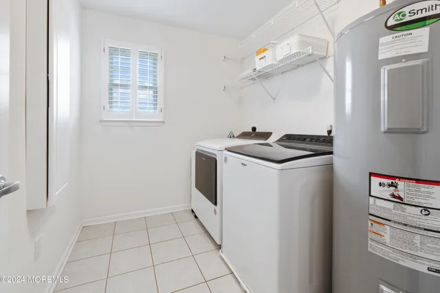 a utility room with cabinets washer and dryer