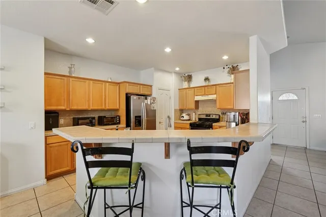 a kitchen with a table and chairs in it