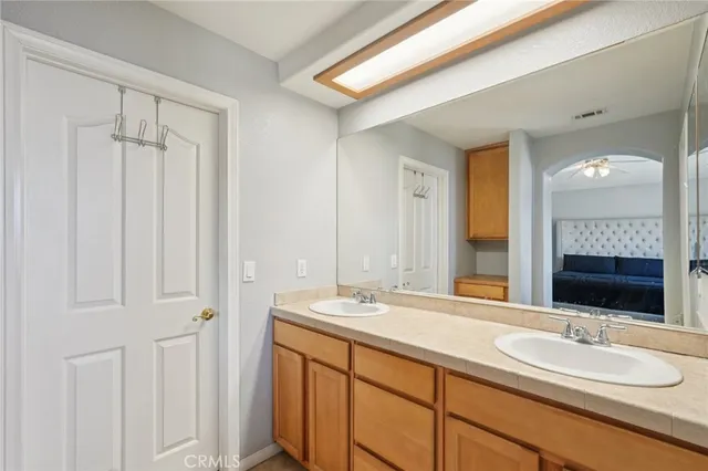 a bathroom with a double vanity sink and a mirror