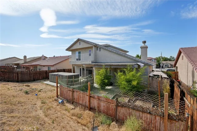 a view of a house with wooden fence
