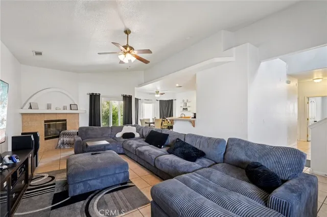 a living room with furniture a fireplace and a chandelier