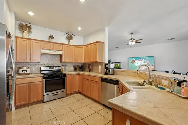 a kitchen with stainless steel appliances granite countertop a sink and cabinets