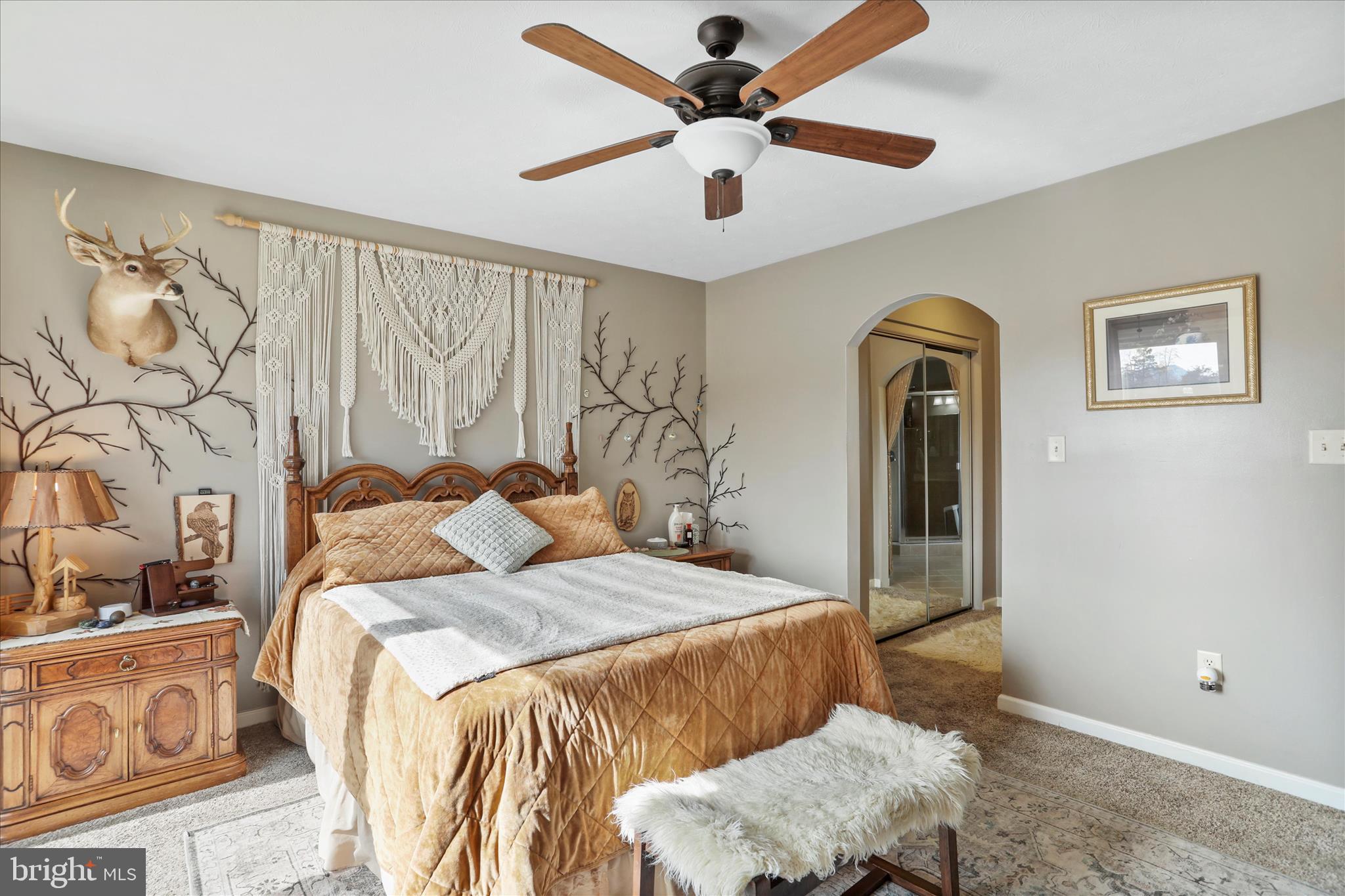 5670 Long Meadow Road Middletown, VA 22645 - Photo 13 of 61 a bedroom with a bed and a chandelier