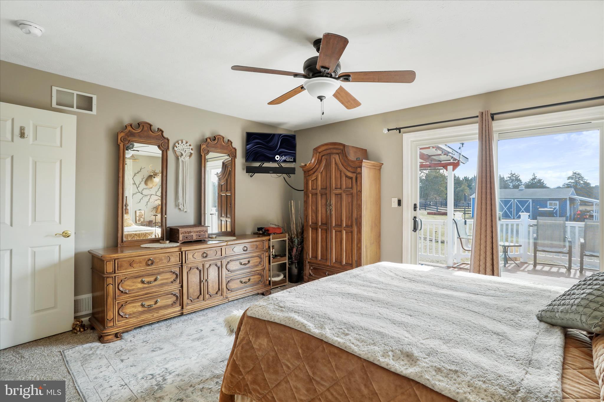 5670 Long Meadow Road Middletown, VA 22645 - Photo 14 of 61 a bedroom with a large bed and a large window