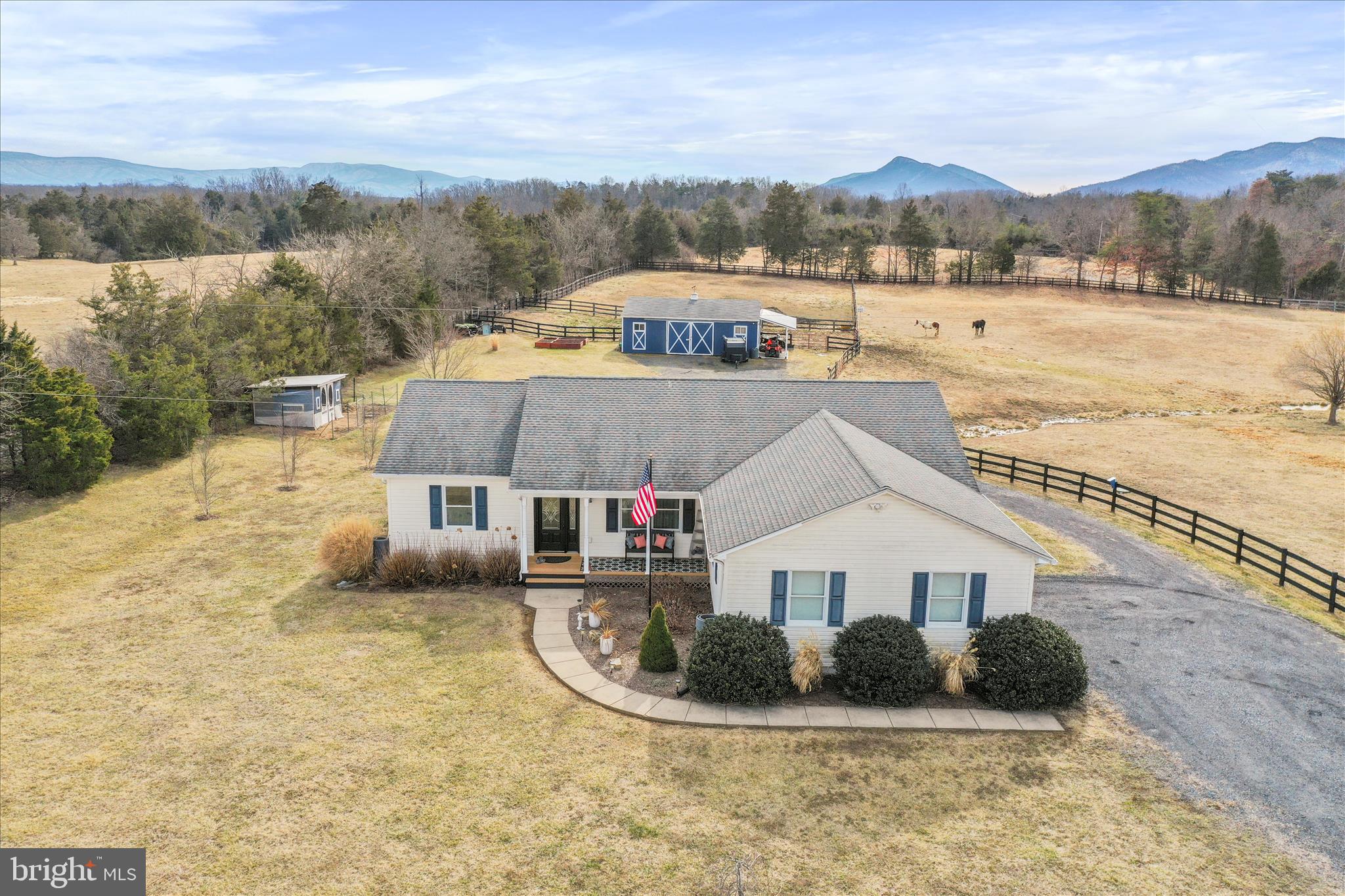 5670 Long Meadow Road Middletown, VA 22645 - Photo 4 of 61 a view of a house next to a lake with a mountain