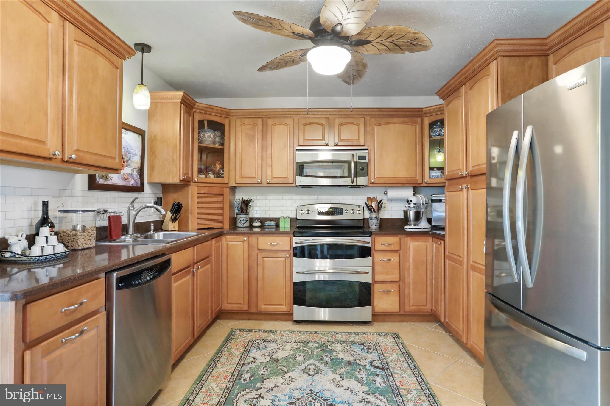 5670 Long Meadow Road Middletown, VA 22645 - Photo 8 of 61 a kitchen with stainless steel appliances granite countertop a refrigerator a stove a sink and a microwave