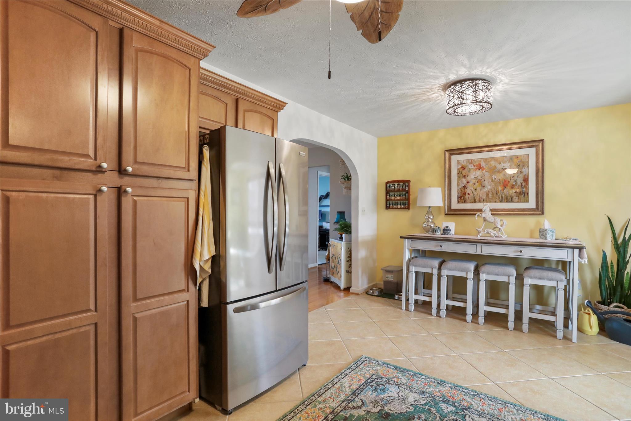 5670 Long Meadow Road Middletown, VA 22645 - Photo 10 of 61 a kitchen with stainless steel appliances granite countertop a refrigerator a stove and a dining table