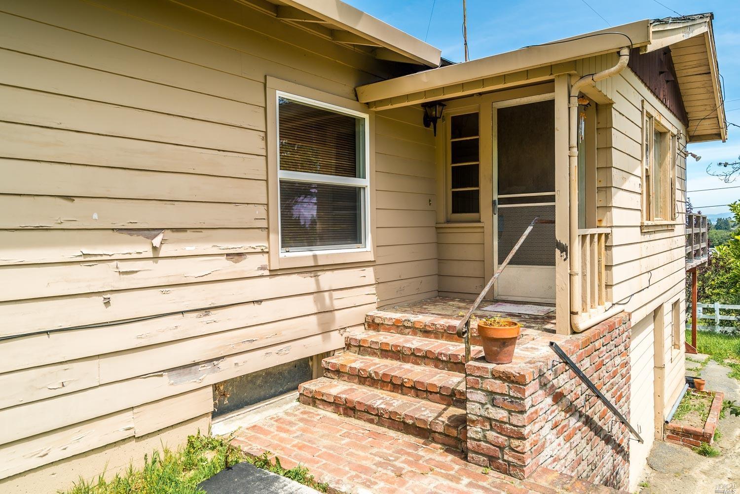 8204 Kennedy Road Sebastopol, CA 95472 - Photo 1 of 1 a view of house with wooden stairs and door