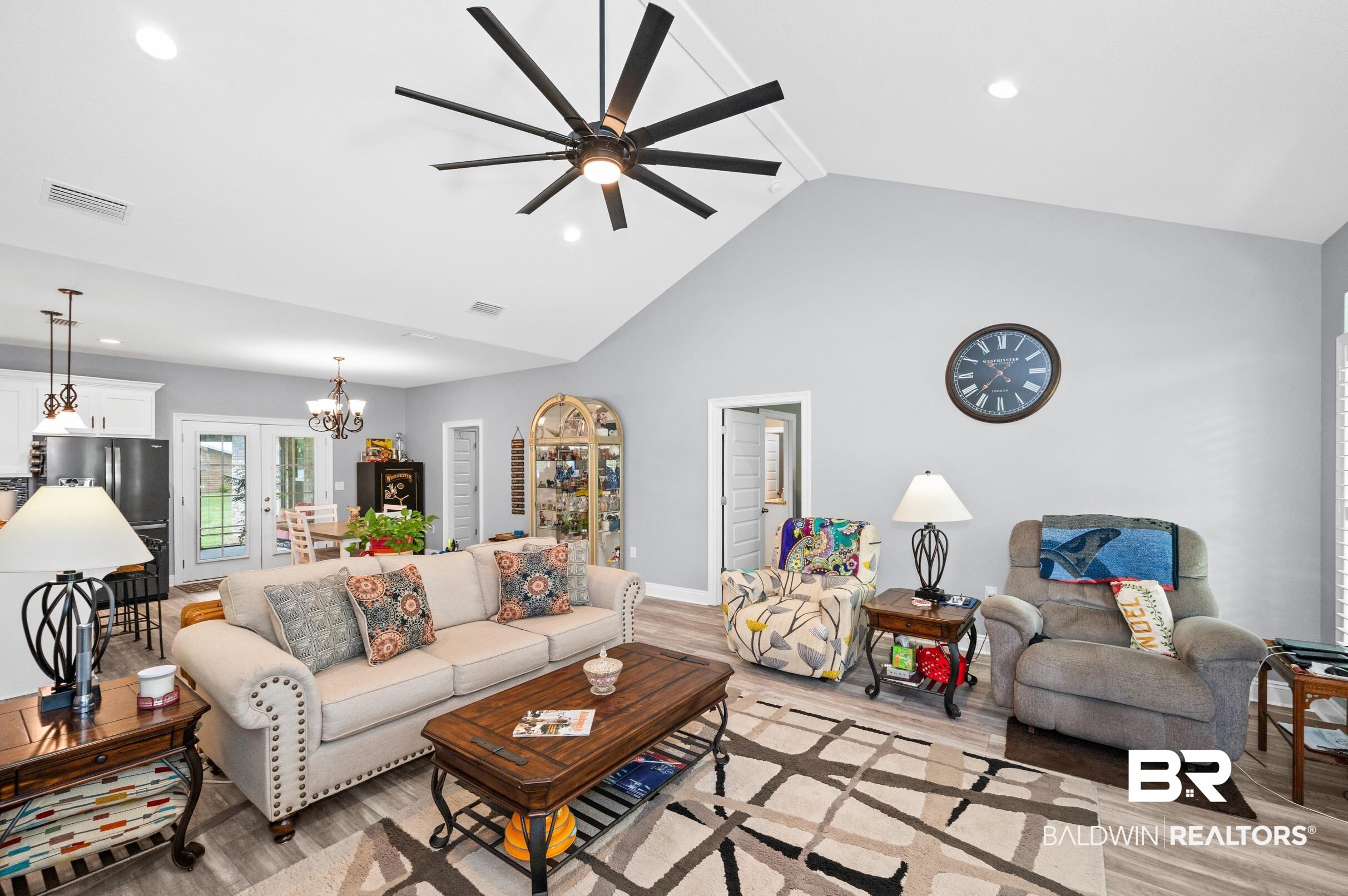 1700 South Juniper Street Foley, AL 36535 - Photo 11 of 51 Living room with ceiling fan with notable chandelier, light hardwood / wood-style flooring, and high vaulted ceiling
