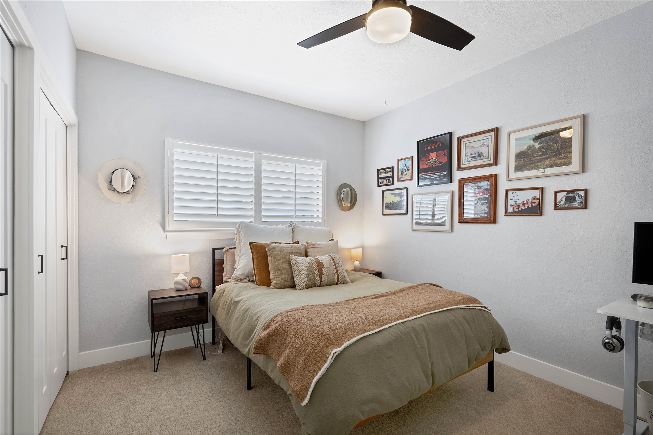 2605 Enfield Road, Unit 221 Austin, TX 78703 - Photo 6 of 30 Bedroom 2 with ensuite bathroom features plantation shutters, a wall of closets and ceiling fan.
