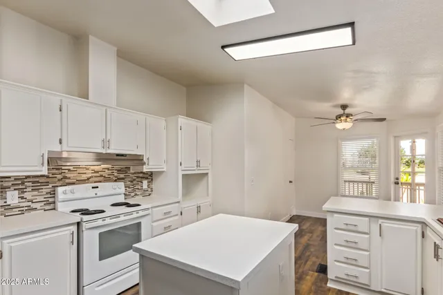a kitchen with a stove a sink and a refrigerator