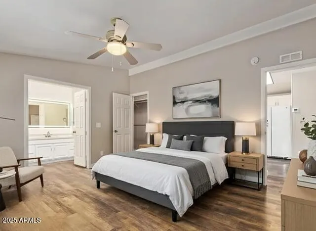 a bedroom with a large bed and a chandelier