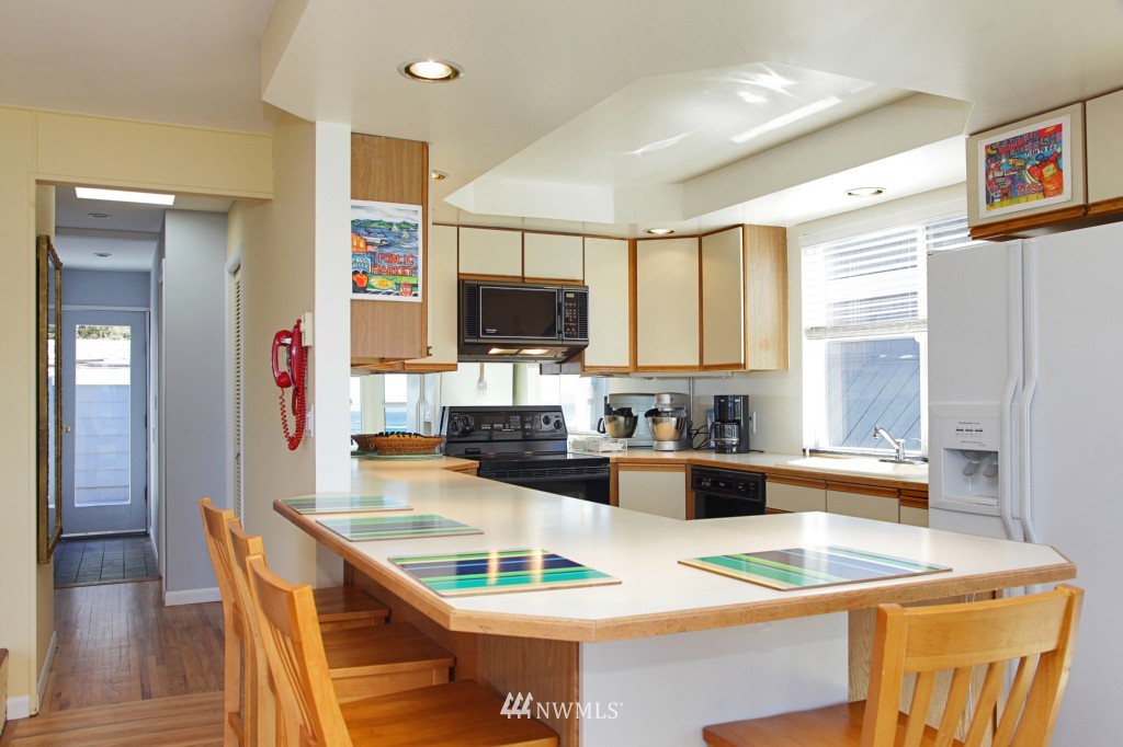 6316 South Bay Road Freeland, WA 98249 - Photo 12 of 15 a kitchen with a stove a sink and a refrigerator