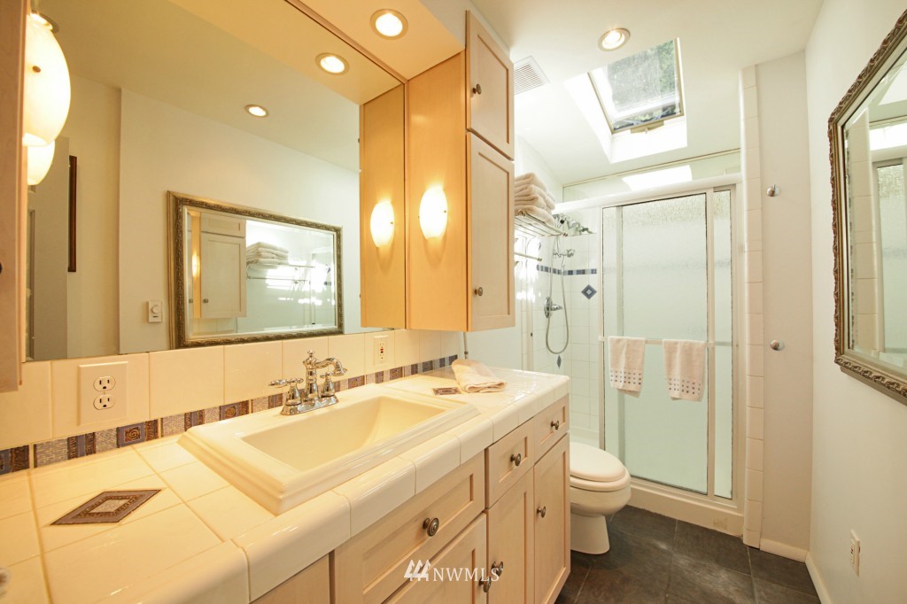 6316 South Bay Road Freeland, WA 98249 - Photo 14 of 15 a bathroom with a double vanity sink toilet and shower
