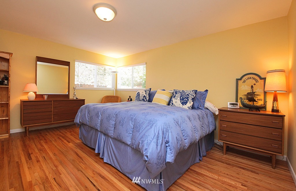 6316 South Bay Road Freeland, WA 98249 - Photo 15 of 15 a bedroom with a bed and wooden floor