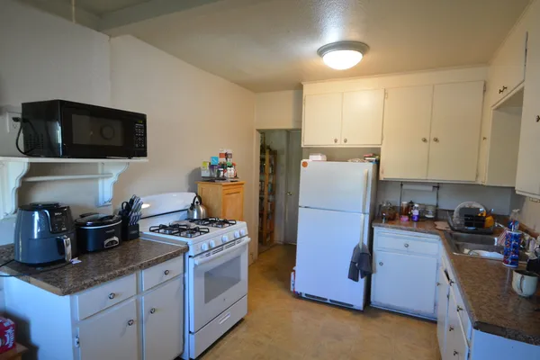 a kitchen with granite countertop cabinets and steel appliances