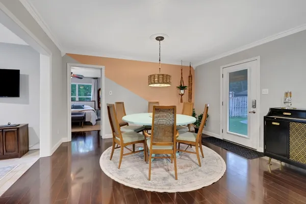 a dining room with furniture and wooden floor