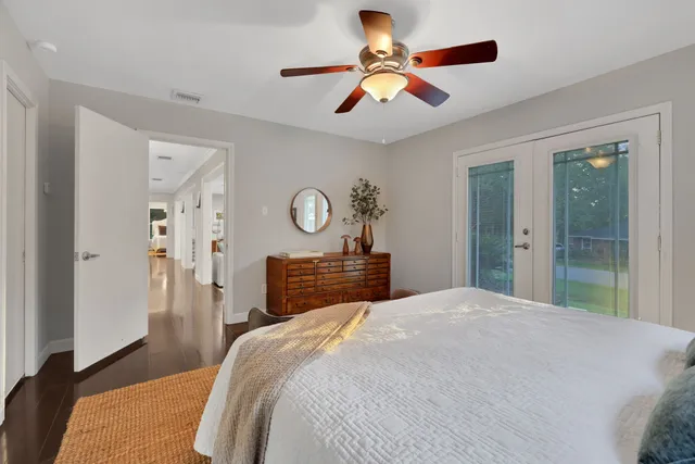 a bedroom with a large bed and a chandelier