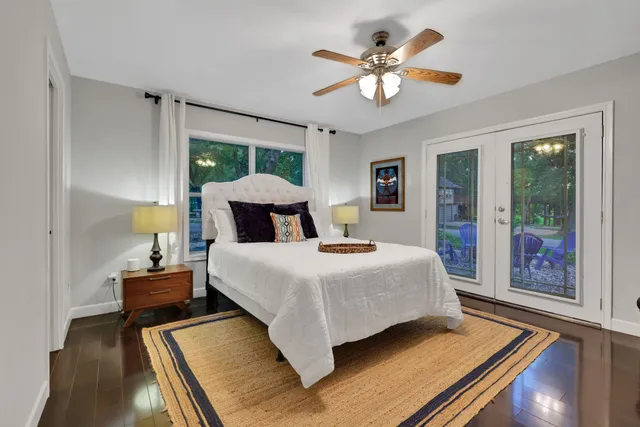 a bedroom with a bed and a chandelier