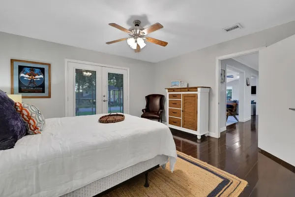 a bedroom with a large bed and a chandelier