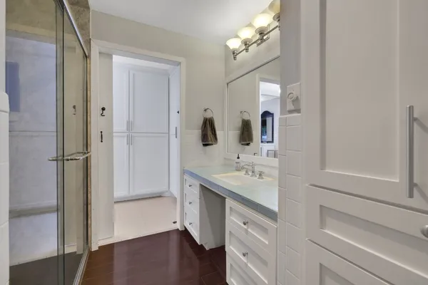 a en suite bathroom with a granite countertop sink and a mirror