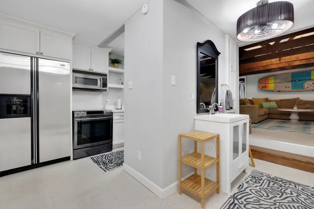 a kitchen with stainless steel appliances kitchen island granite countertop a refrigerator and a stove