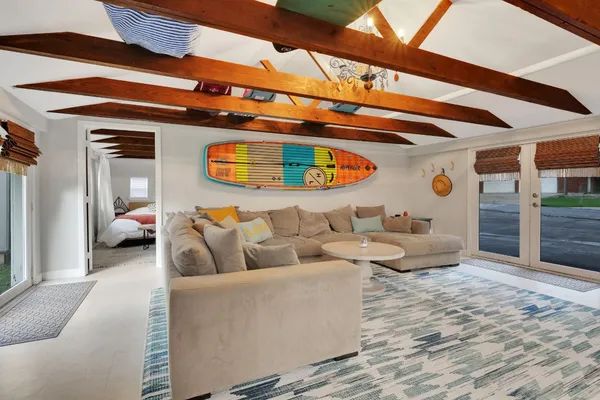 a living room with furniture and a ceiling fan