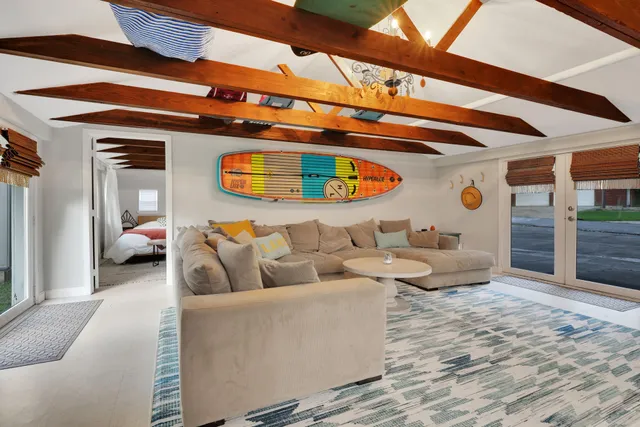 a living room with furniture and a ceiling fan