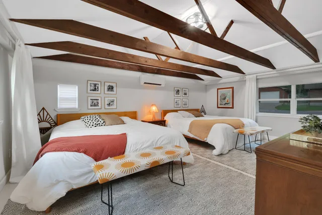 a bedroom with furniture and a lamp