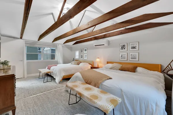 a bedroom with double bed and a window