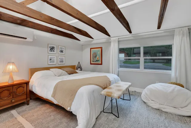 a spacious bedroom with a bed and a window