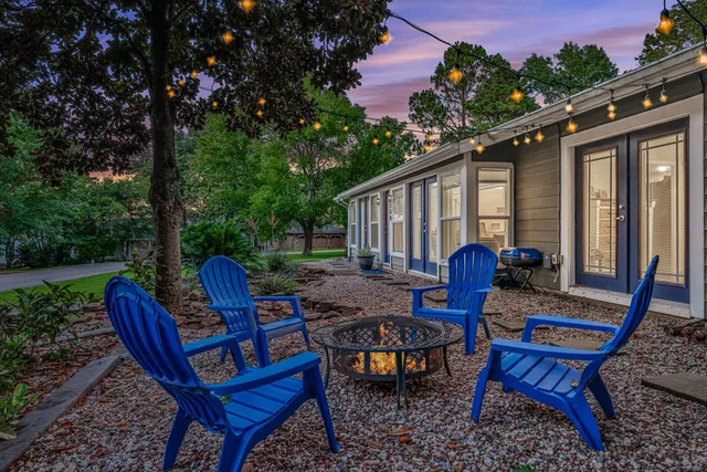 a backyard of a house with wooden floor outdoor seating