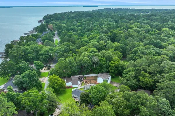an aerial view of a house with outdoor space lake view and sitting space