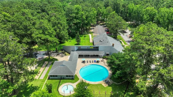 an aerial view of a house with a swimming pool