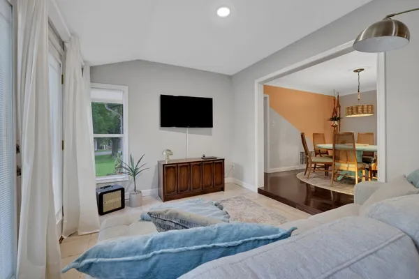 a living room with furniture a fireplace and a flat screen tv