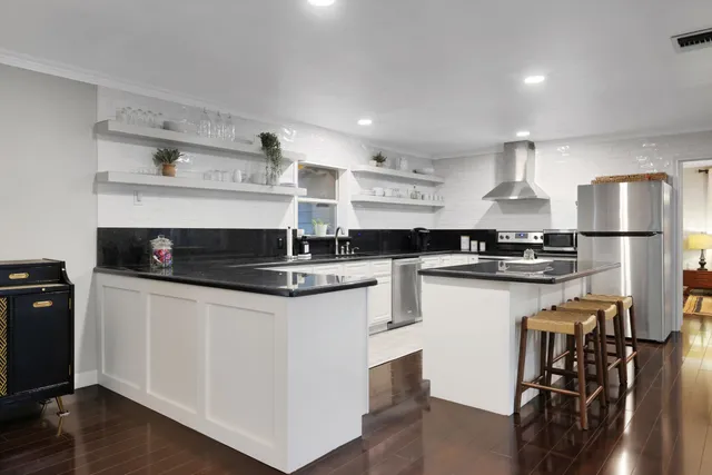 a kitchen with a refrigerator and a stove top oven