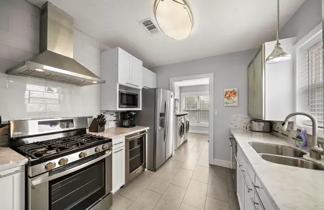 a bathroom with a granite countertop toilet sink and mirror