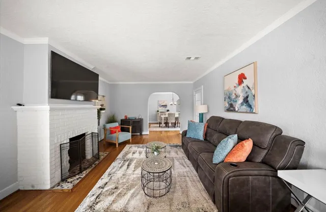 a living room with furniture fireplace and flat screen tv