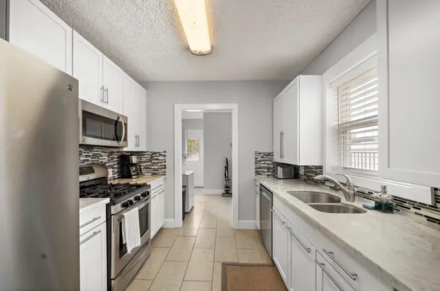 a bathroom with a double vanity sink toilet and a mirror