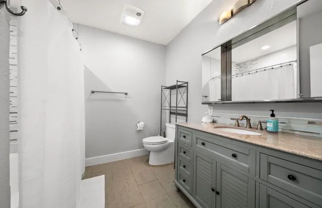 a bedroom with a large bed and a large window