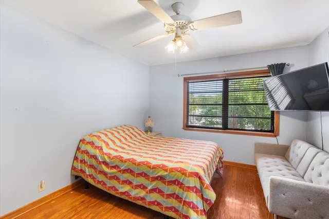 a bedroom with a bed and a window