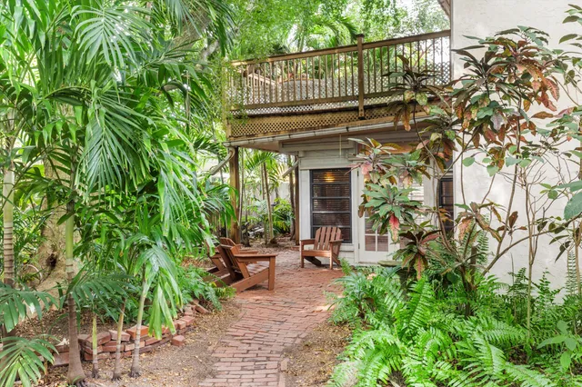 a view of a chair and tables in the backyard of the house